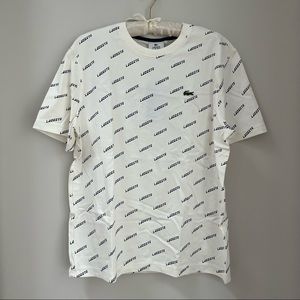 Never worn Lacoste tee with Lacoste logo navy pattern.
